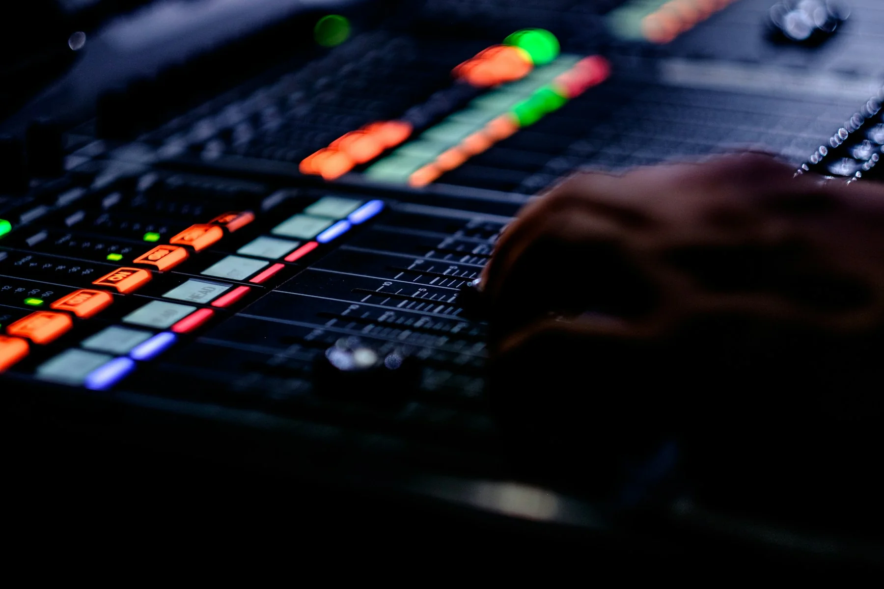 Hænder på en mixer under arbejdet med en beatproduktion
